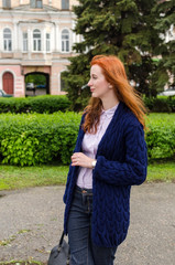 Young red woman walking in the city