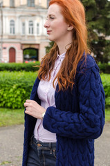 Young red woman walking in the city