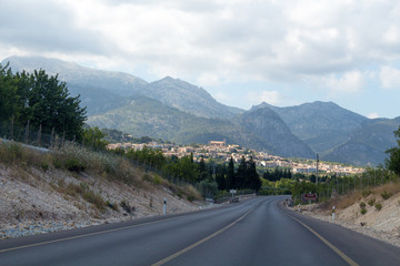Empty road to a town in mountains