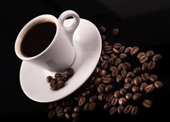 Coffee cup with coffee beans surrounding 