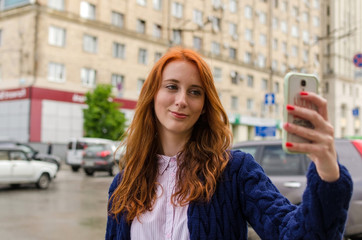 Young red woman making selfie 