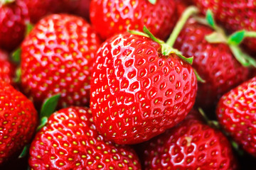 Fresh ripe perfect red strawberry - food frame background, closeup.