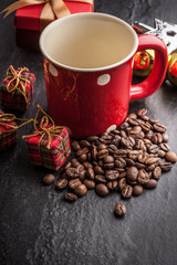 Red mug and Christmas tree with decoration on dark stone background