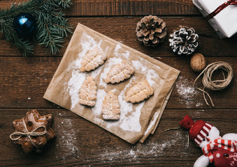 Christmas decorated table with sweet cookies, toys and gifts. Concept of new year celebration, tradition and warmth. 