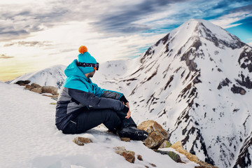 Fototapeta na wymiar Explorer on the top of a snowy mountain, enjoying the view.