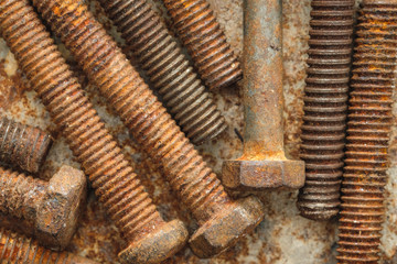 old rusty bolts dirty on rusty metal plate background