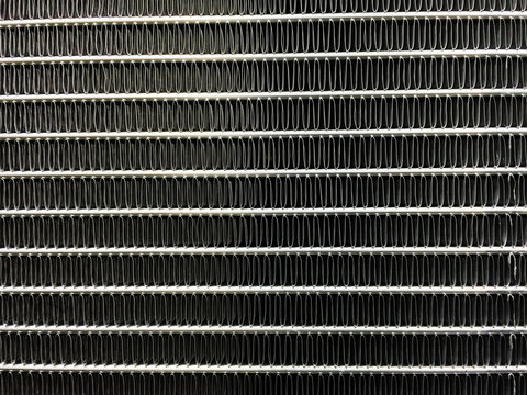 Condenser unit used in central air conditioning systems - heat exchanger (heat micro canel) section to cool down and condensate incoming refrigerant vapor into liquid. background  texture. technology.