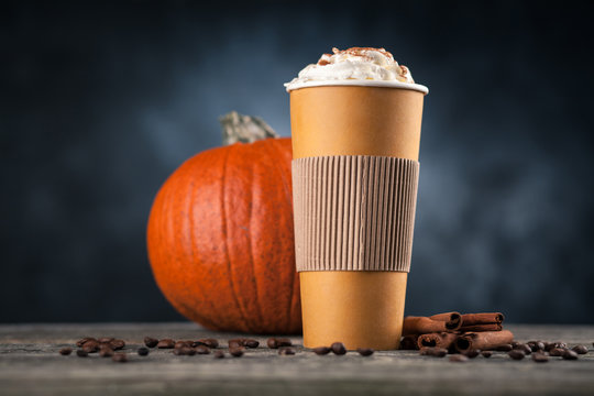 Pumpkin spice latte in a paper cup
