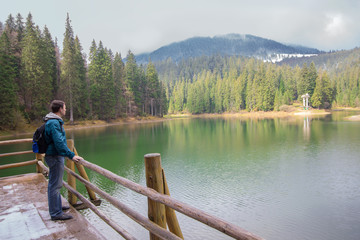 Tourist with backpack near a beautiful lake. Travels