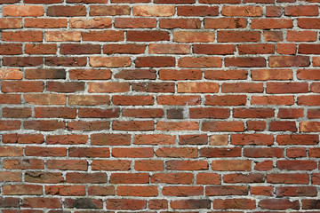 A brick wall fitted with a concrete seam