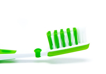 green toothbrush isolated on white