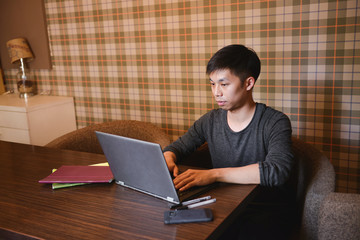 student using laptop in cafe