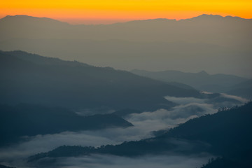 Beautiful sunrise scene with misty in morning in forest valley in Huay Nam Dang National Park. Chiang Mai, Thailand.