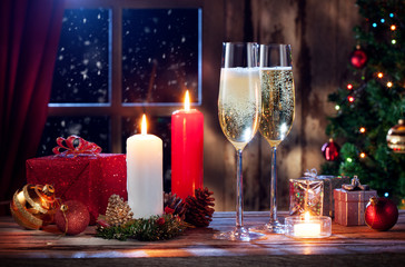 close up view of champagne with candles and gifts on color back