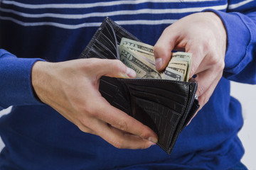 wallet with money in the hands of a man