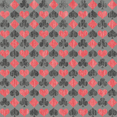 Card symbols in a grunge design on gray, a seamless background pattern
