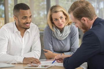 Mutiracial couple with a .real estate agent