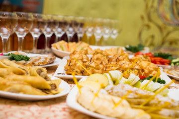 catering banquet table, Canapes on restaurant table, catering, buffet, canapés, stemware, snacks, glasses with juice, champagne glasses