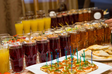 catering banquet table, Canapes on restaurant table, catering, buffet, canapés, stemware, snacks, glasses with juice, champagne glasses