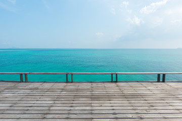 Fototapeta na wymiar wooden floor with beautiful ocean and blue sky scenery