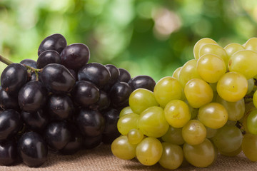 Blue and green grapes on the table with a blurred background