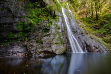Waterfall and its reflection in the pool