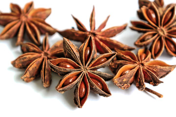 Star shaped anise seeds on a white background