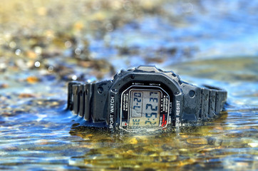 Electronic waterproof watch, immersed in the water stream.