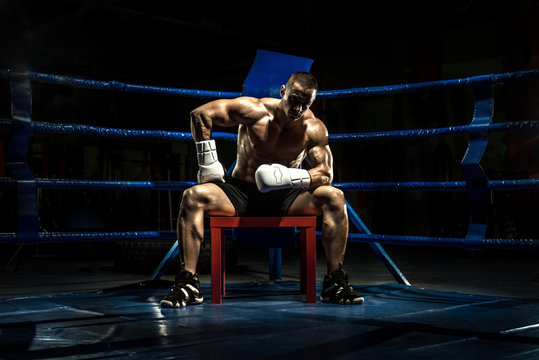 boxer on boxing ring, tired time-out