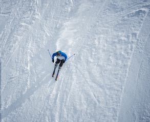 Man skiing down the slope. Shot from above.