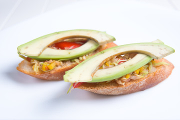 Bruschetta crostini with chopped vegetables and avocado. Italian food