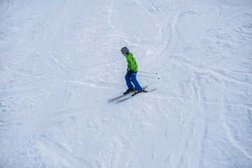 Young boy skiing down the mountain slope.