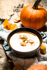 pumpkin soup with seeds on the old fabric.