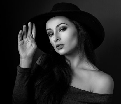 Expressive bright makeup woman in fashion elegant hat posing on