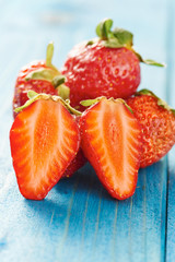 Strawberries on blue wooden table