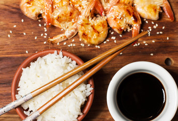 Rice with shrimp and soy sauce on a black background, horizontal, soft focus