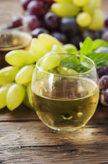 White grapes juice on the wooden table