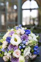 Romantic fresh wedding bouquet on background of house with windows