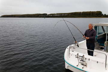 Fototapeta na wymiar fisherman is fishing on a dark lake