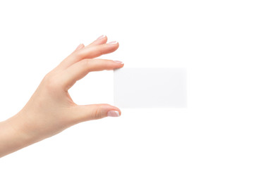 Female hand holds white card on a white background.
