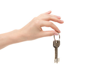 Female hand holds keys on white background.