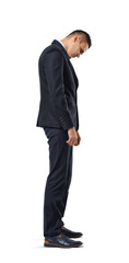 Businessman stands in profile hanging his head , isolated on a white background.