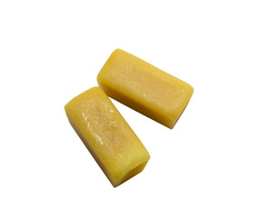 two caramel candies on white