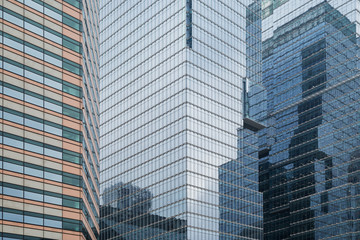 Obraz premium Skyscrapers reflective glassy walls and reflections of another buildings on them in Seoul, South Korea.