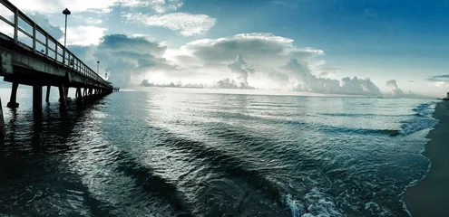 Papier Peint photo Jetée pier and the ocean with cloudy blue sky, Florida