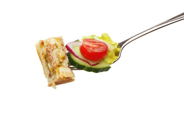 Pie and salad on fork