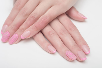 Multi-colored jelly sweets in the hands with a bright nail polish