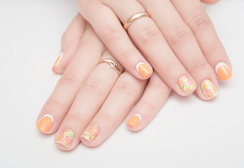 Naklejka premium Multi-colored jelly sweets in the hands with a bright nail polish