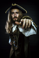 Fototapeta premium portrait of bearded and hairy pirate pointing into the distance, shallow DOF