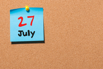 July 27th. Day 27 of month, color sticker calendar on notice board. Summer time. Empty space for...